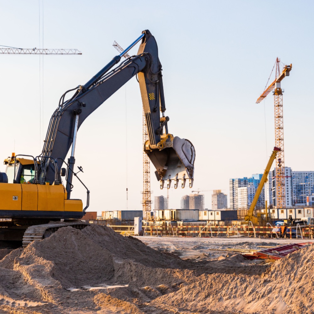 Excavator working an active commercial construction site